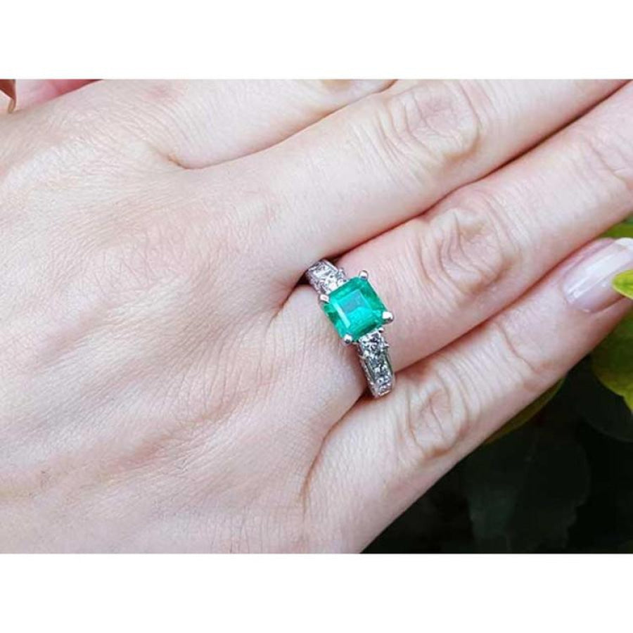 1.62 ct. square emerald ring with princess cut diamonds on a 14K white gold band.