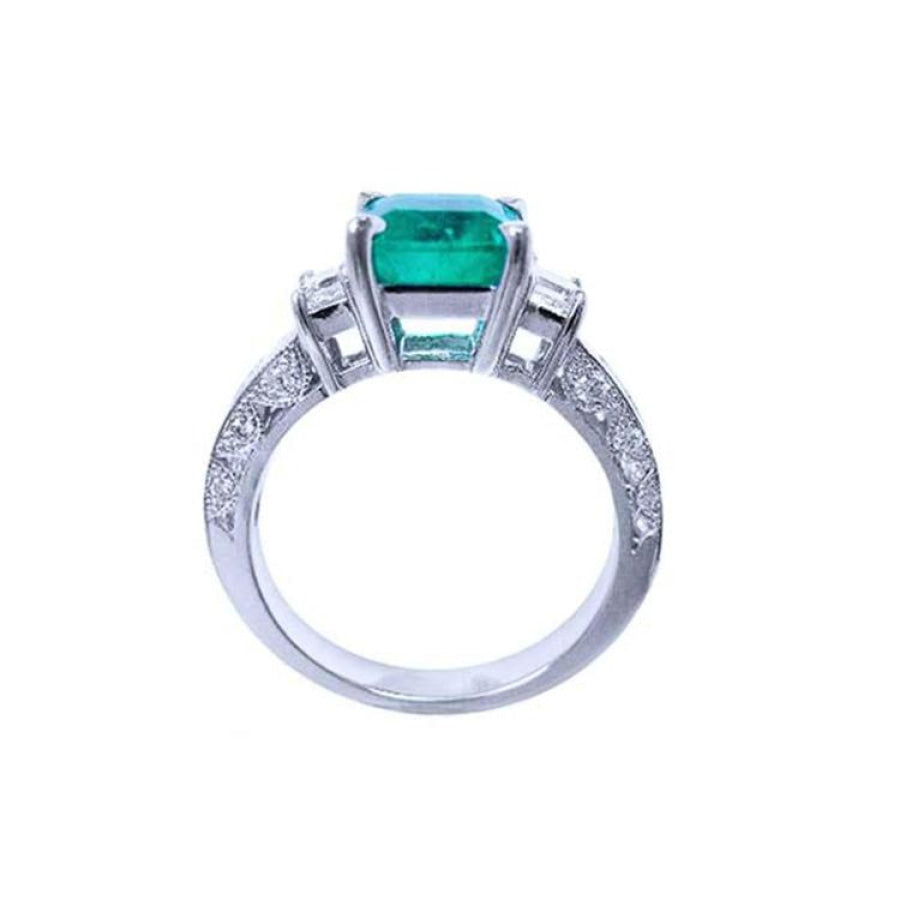 1.62 ct. square emerald ring with princess cut diamonds on a 14K white gold band.
