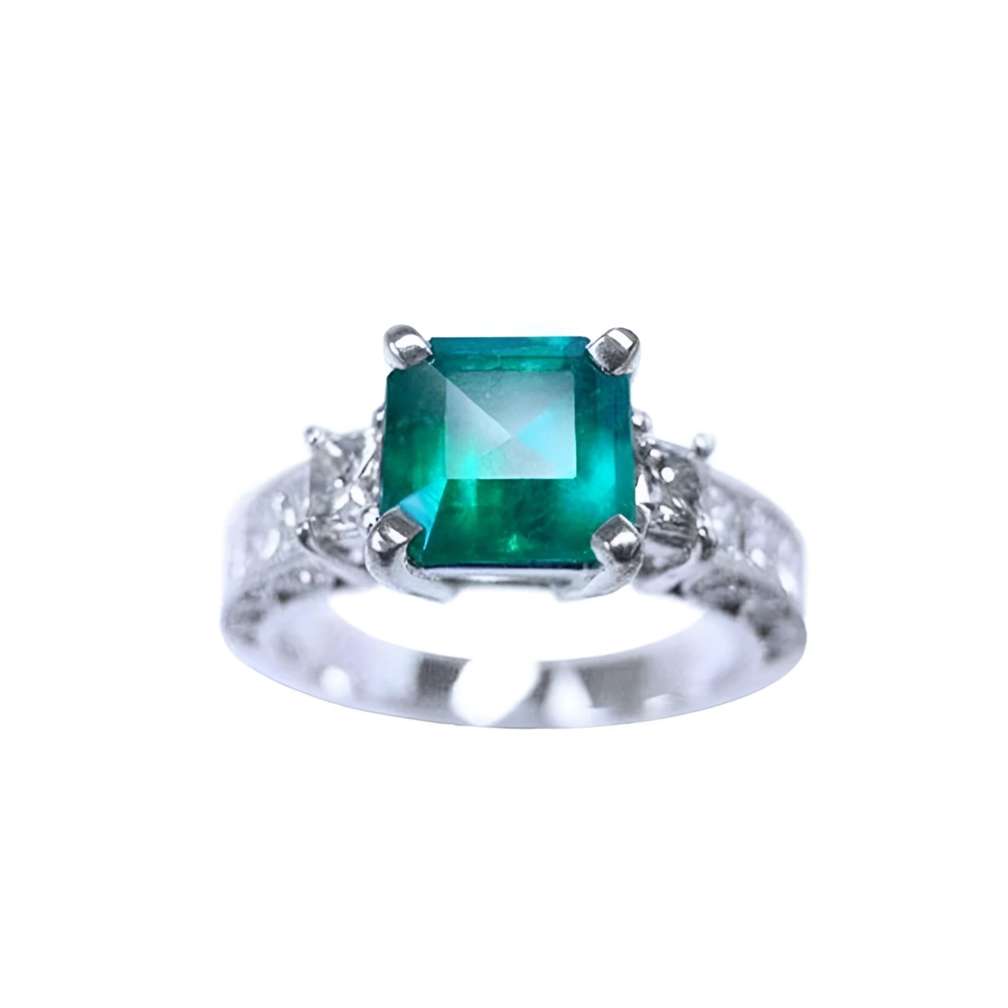 A real colombian emerald ring with side princess cut diamonds crafted in 14k white gold.