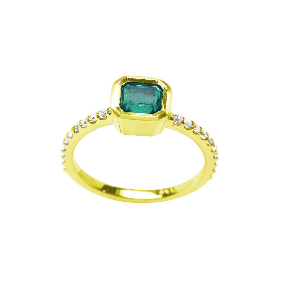 14k yellow gold emerald ring and diamond-studded band on a white background.