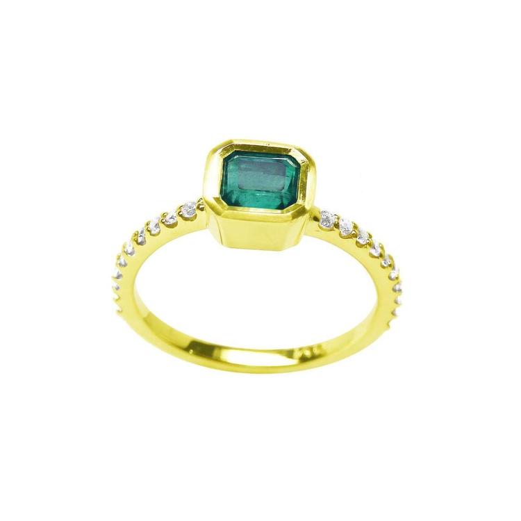 Bezel-set emerald ring with accent diamonds on a 14K yellow gold band.