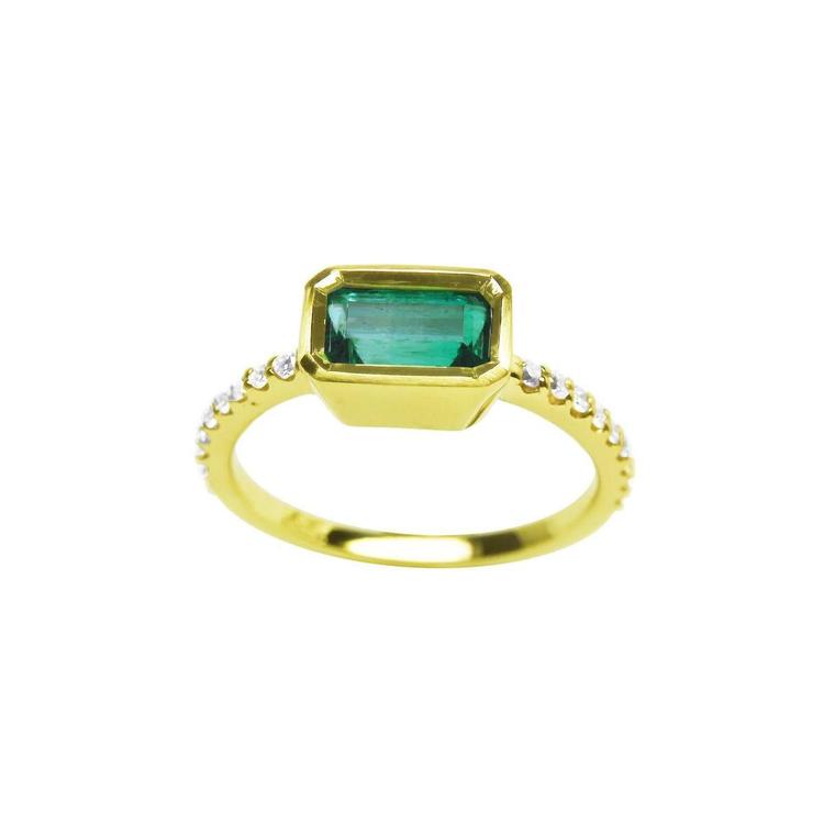 An east-west bezel set emerald ring in yellow gold with accent diamonds, is the perfect May's birthstone gift.