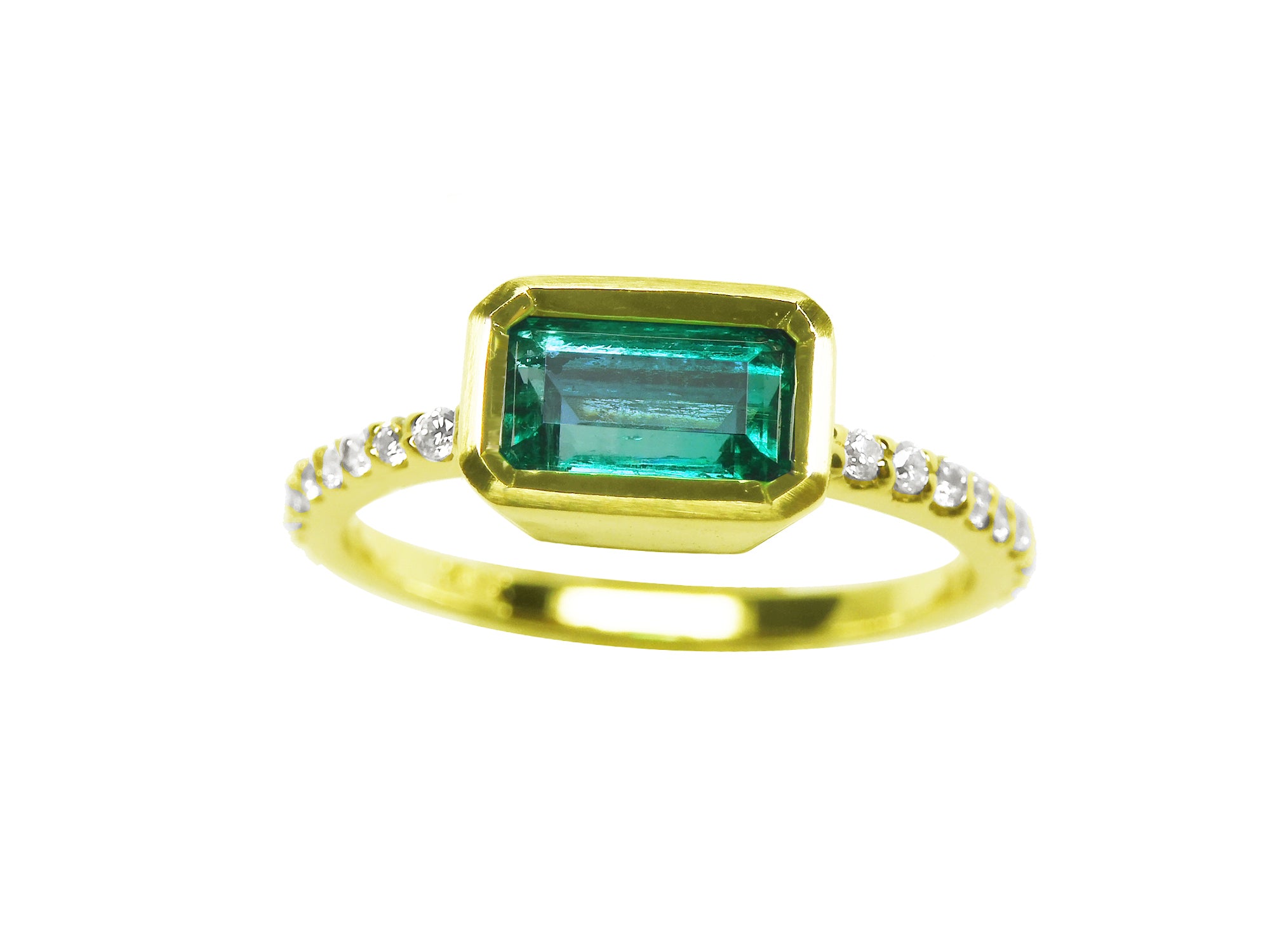 A yellow gold emerald ring bezel set with natural accent diamonds is the perfect gift as a May birthstone.