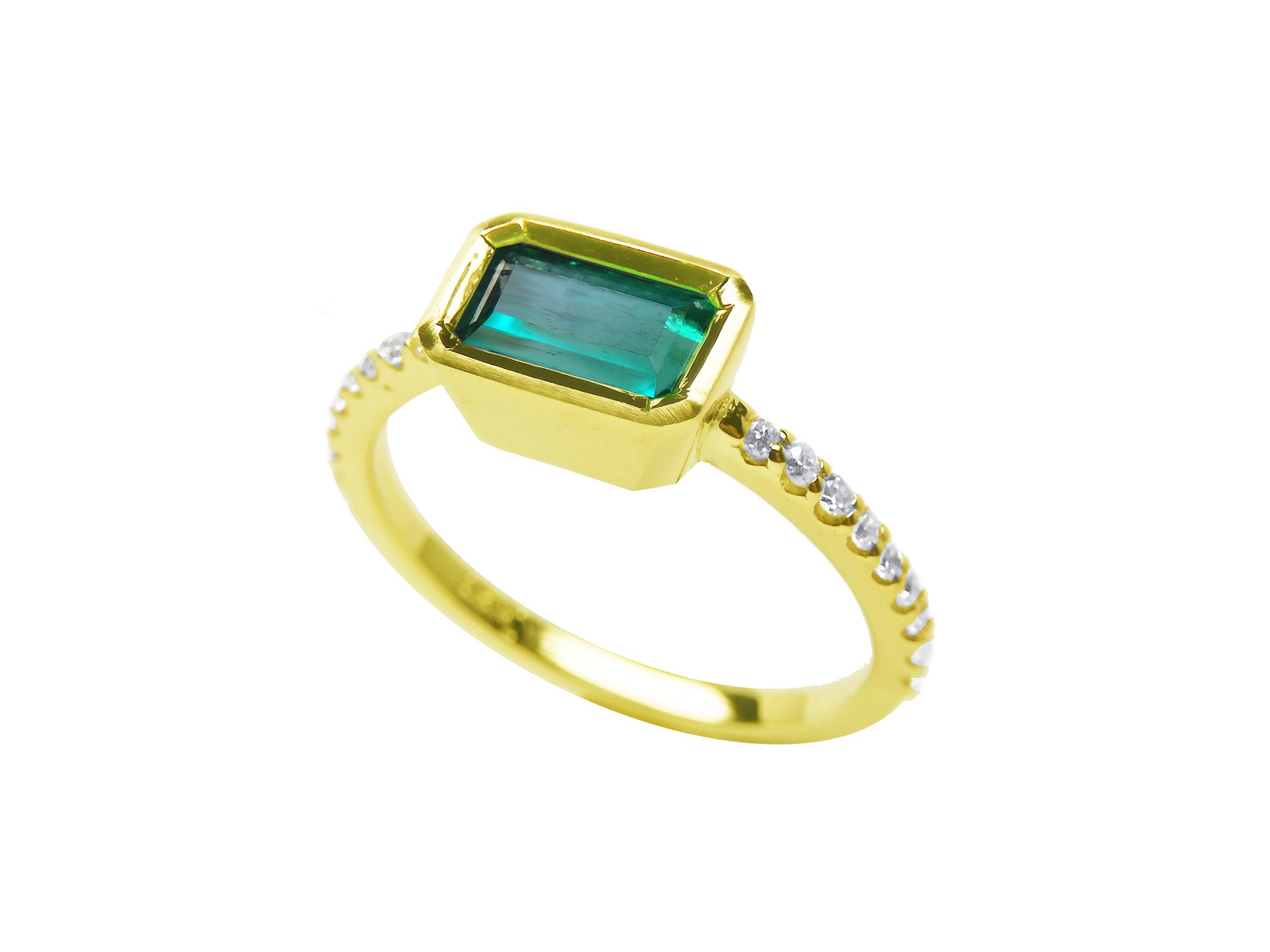 A yellow gold emerald bezel set ring, displaying the top and side diamonds accent along the band.