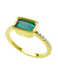 A yellow gold emerald bezel set ring, displaying the top and side diamonds accent along the band.