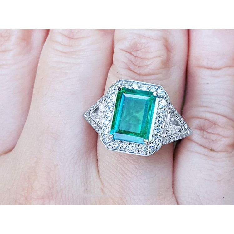 A GIA certified natural Colombian emerald ring for women 18k white gold on a woman's hand.