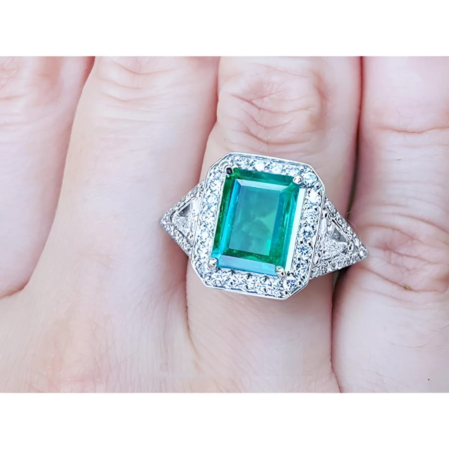 A GIA certified natural Colombian emerald ring for women 18k white gold on a woman's hand.