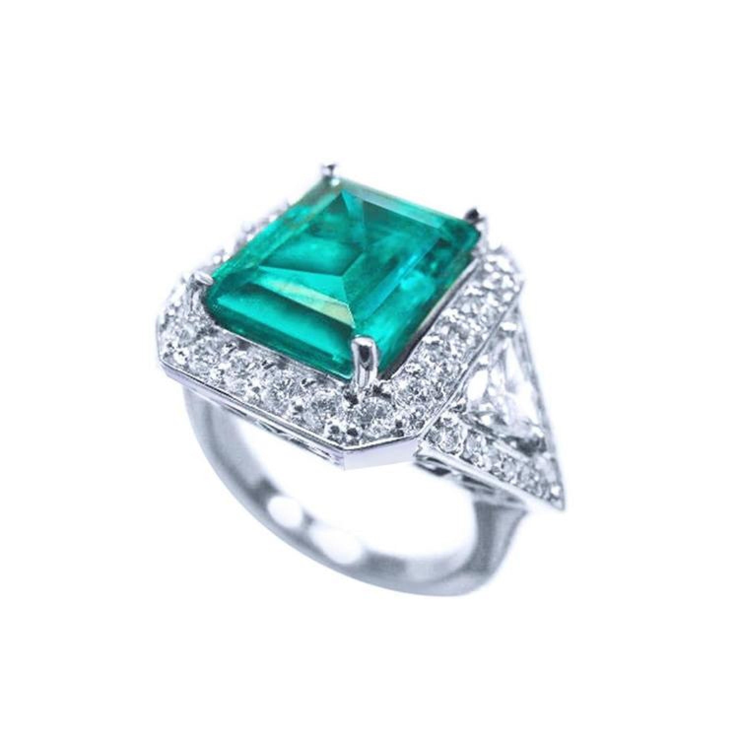 18K white gold ring with a rectangular emerald, diamond halo, and trillion side diamonds.