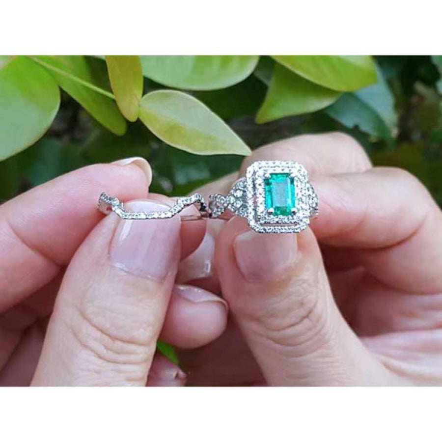 1.01 carat emerald ring with double halo diamonds and matching band in 14K white gold.