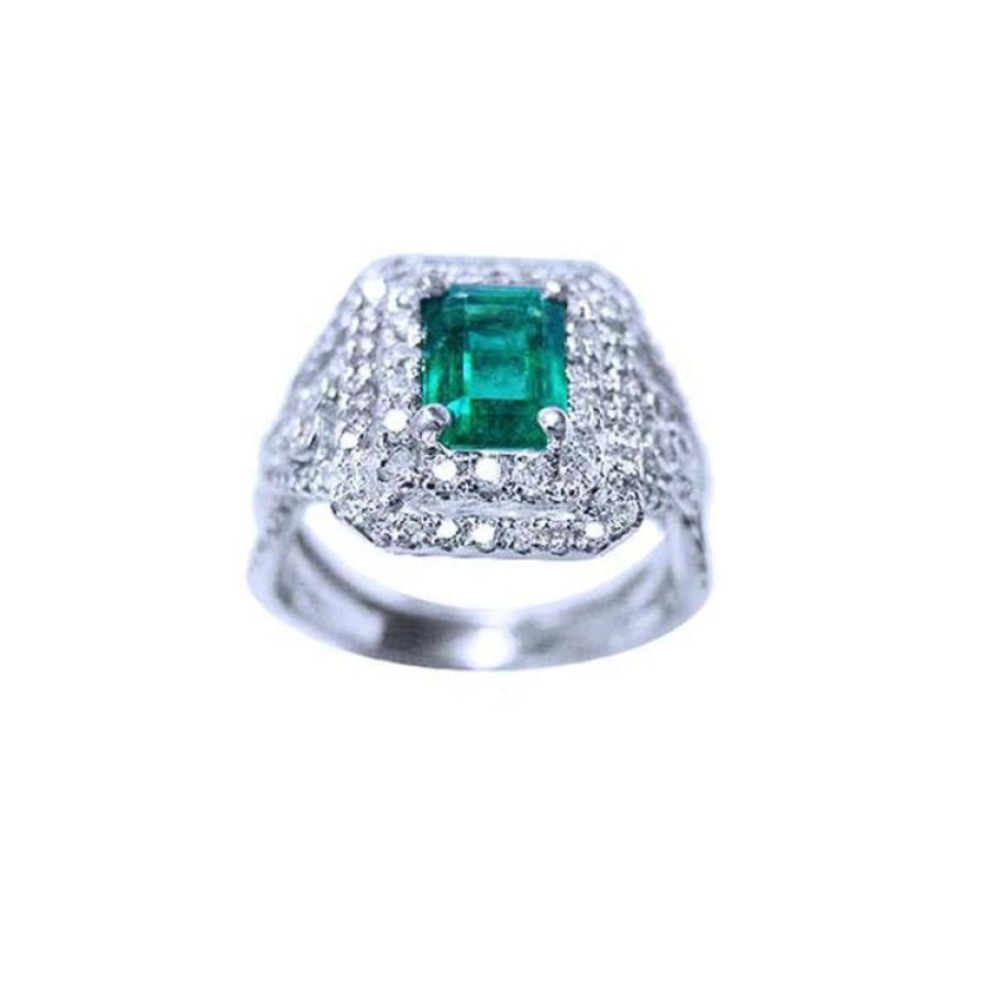 1.01 carat emerald ring with double halo diamonds and matching band in 14K white gold.