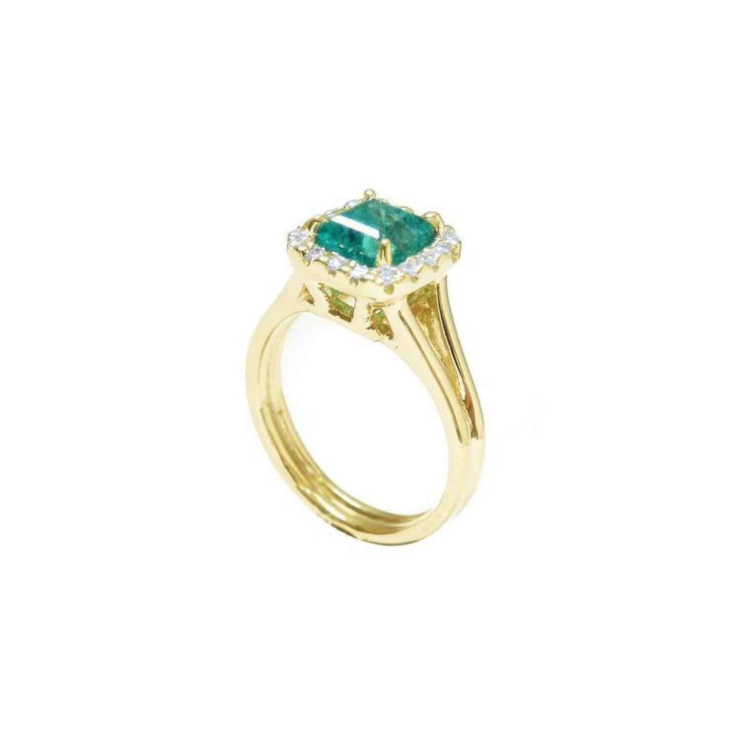 1.27 carat Colombian emerald ring in 14K yellow gold with halo diamonds and a split shank.