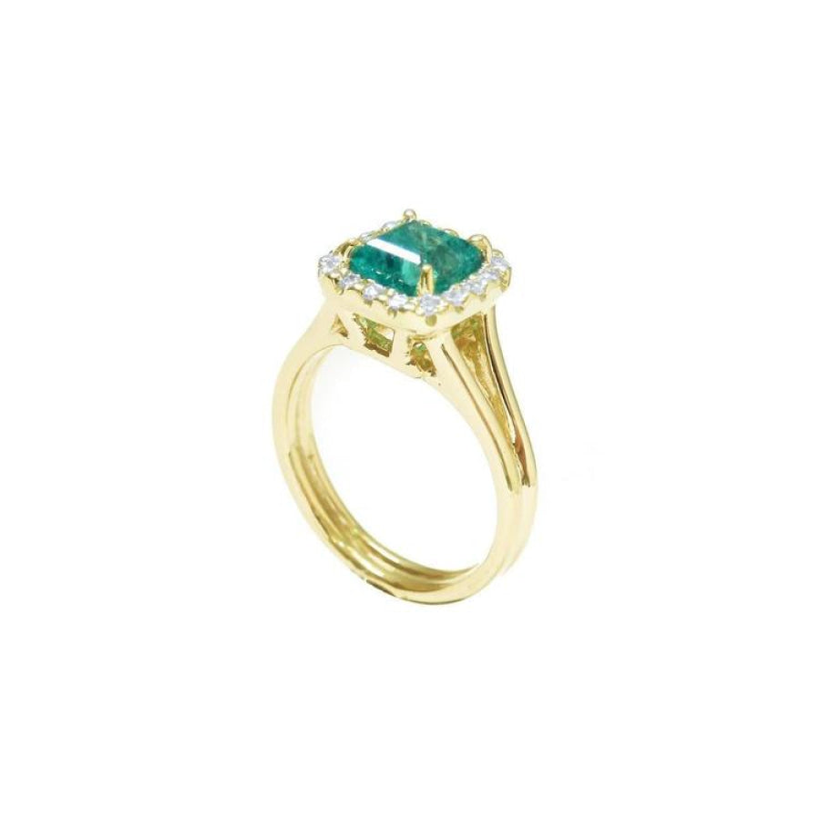 1.27 carat Colombian emerald ring in 14K yellow gold with halo diamonds and a split shank.
