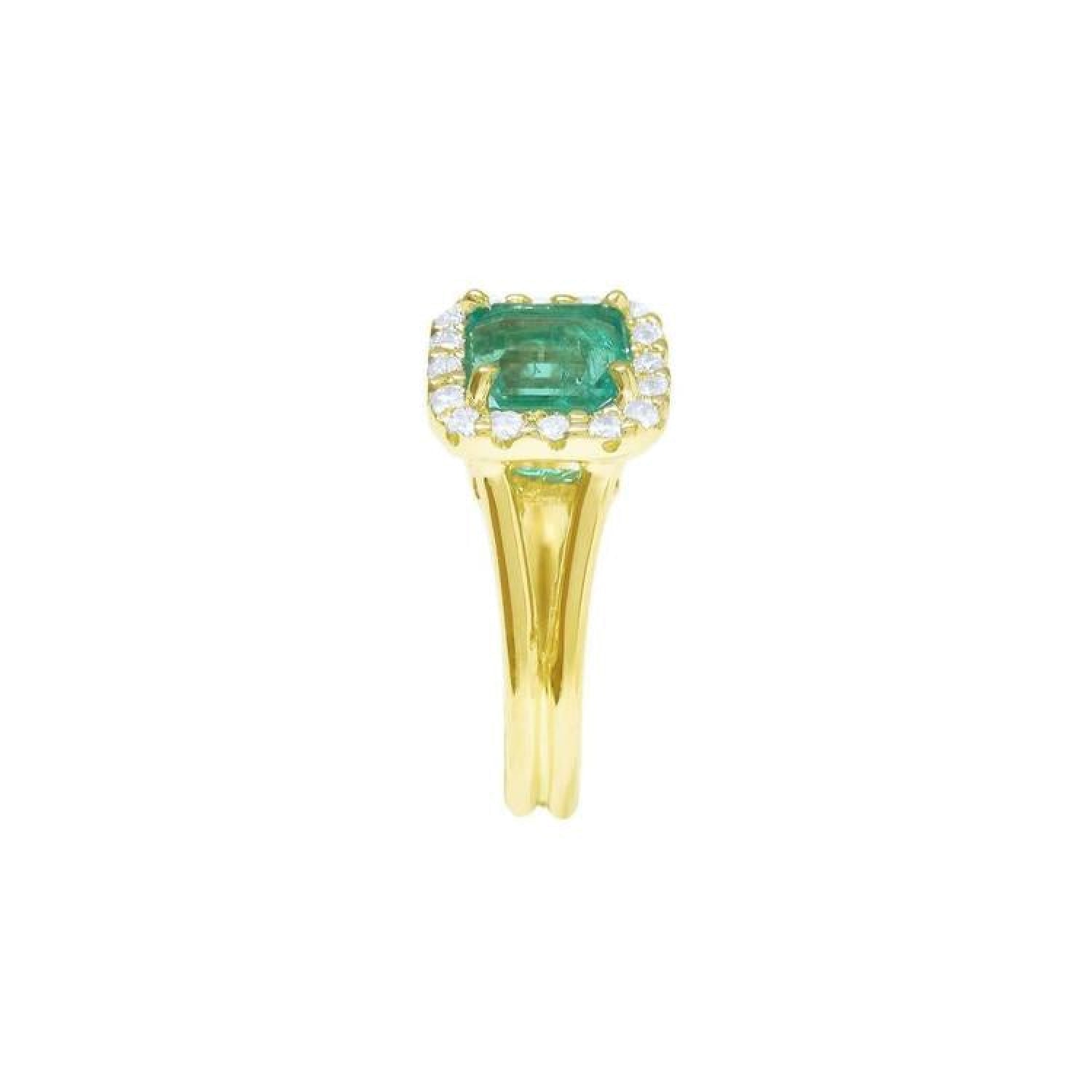 14K yellow gold ring with a square Colombian emerald haloed by diamonds on a split shank.