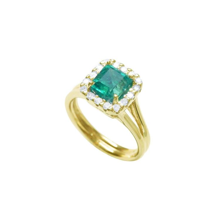 1.27 carat Colombian emerald ring in 14K yellow gold with halo diamonds and a split shank.