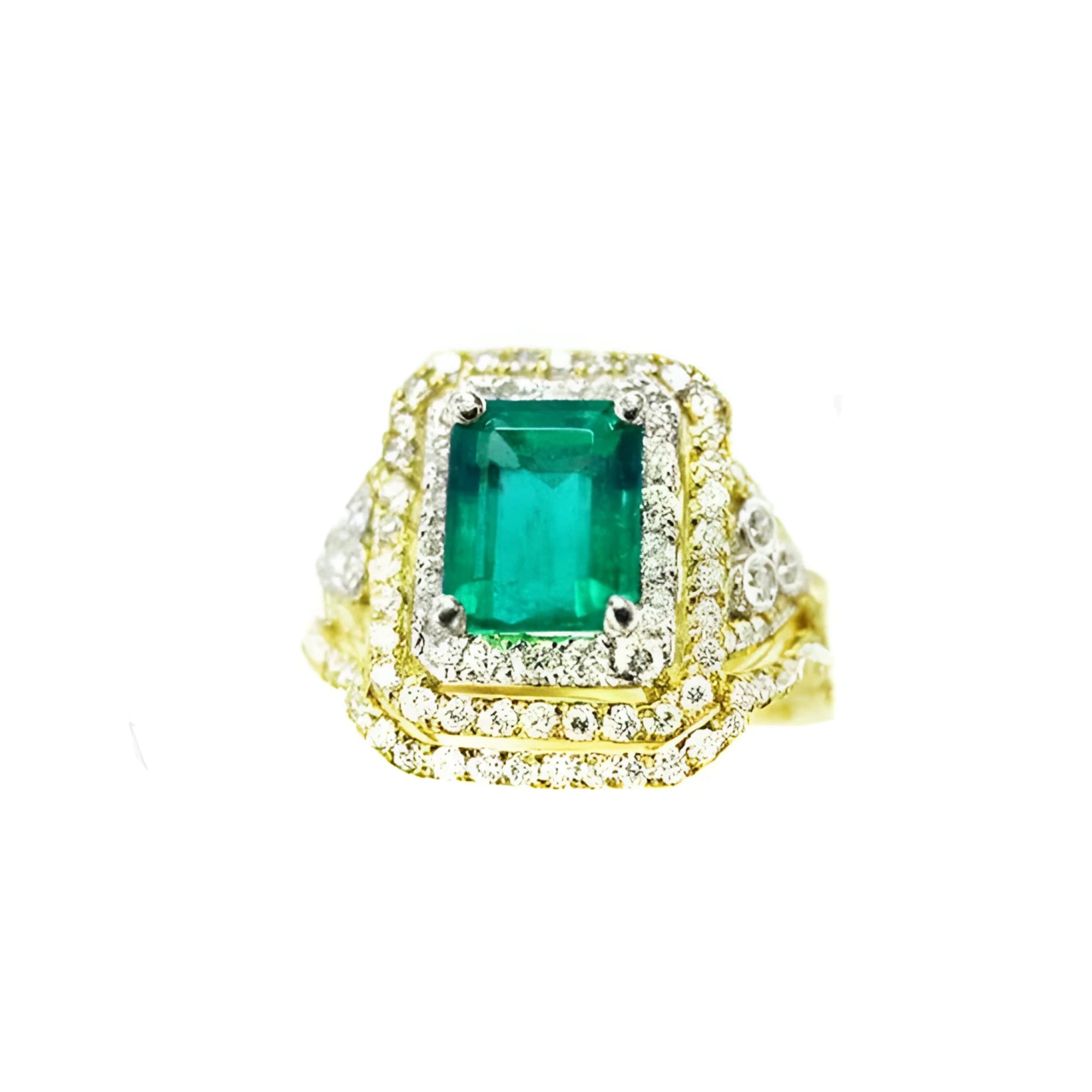 This Colombian emerald ring with matching band has a double halo of diamonds and it was crafted in 14k yellow gold.