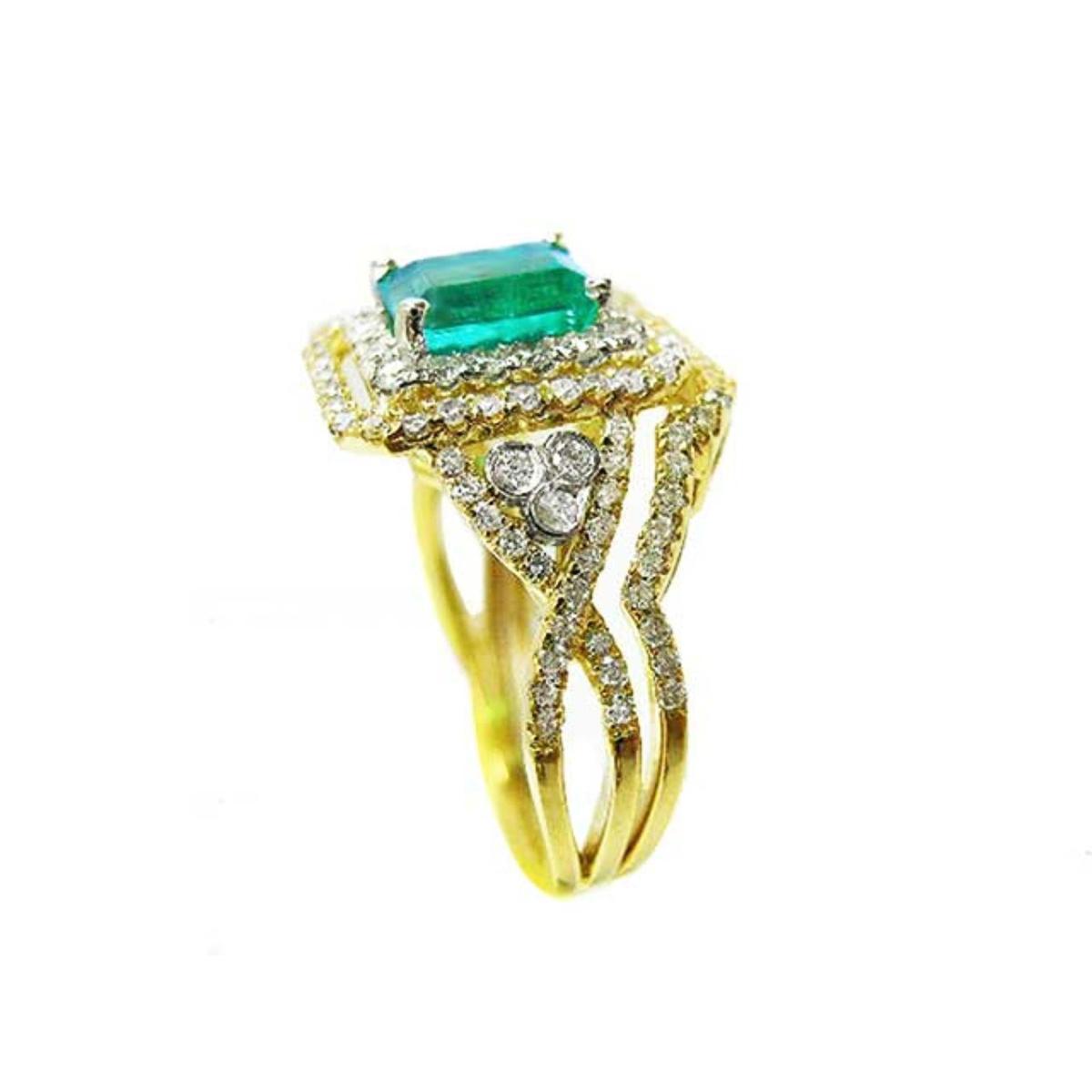 Side profile of a yellow gold emerald and matching band ring with accent diamonds, top gemstone and side bands profile visibles.