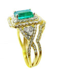 Side profile of a yellow gold emerald and matching band ring with accent diamonds, top gemstone and side bands profile visibles.