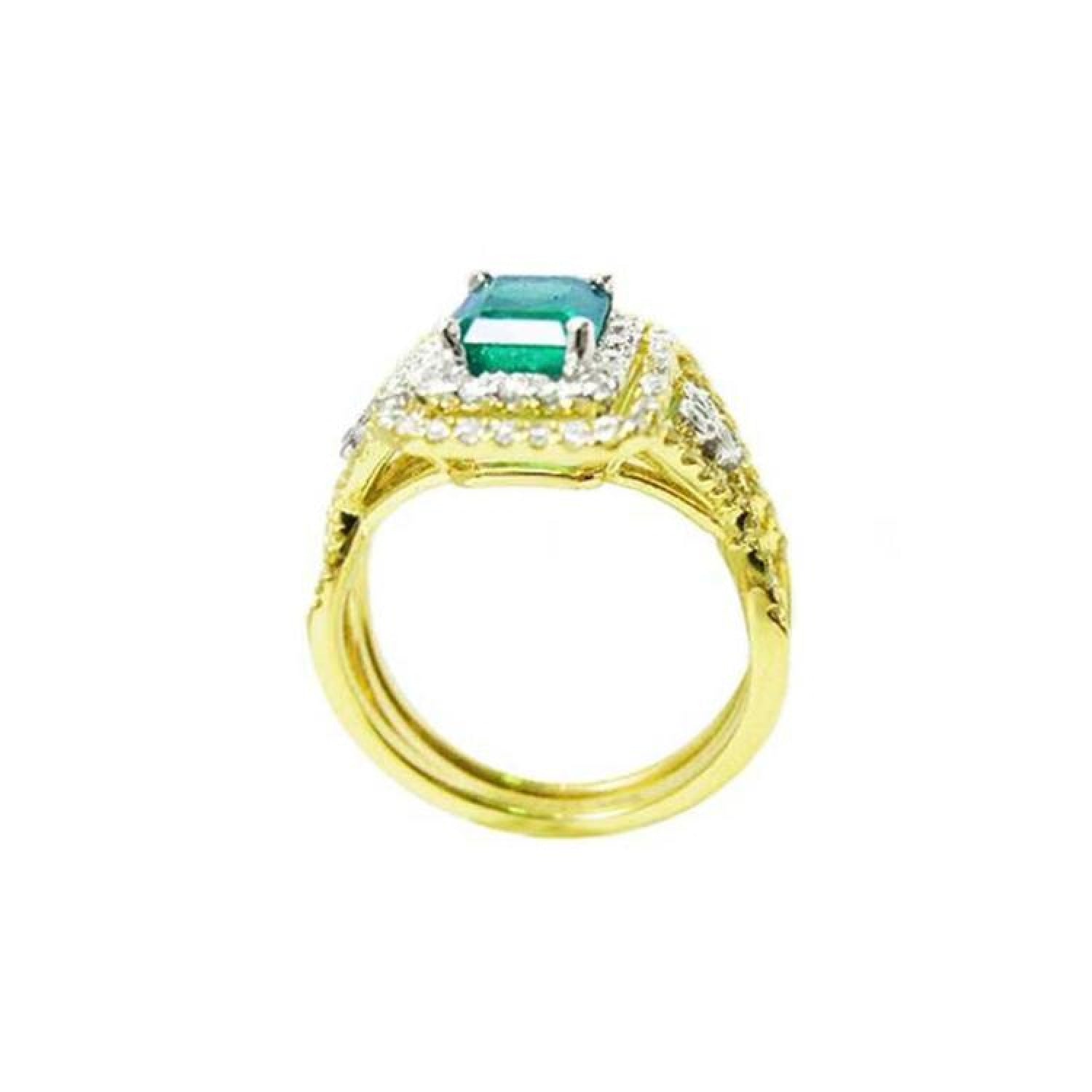 1.31 ct emerald-cut emerald ring with double diamond halo and matching band in 14K yellow gold.