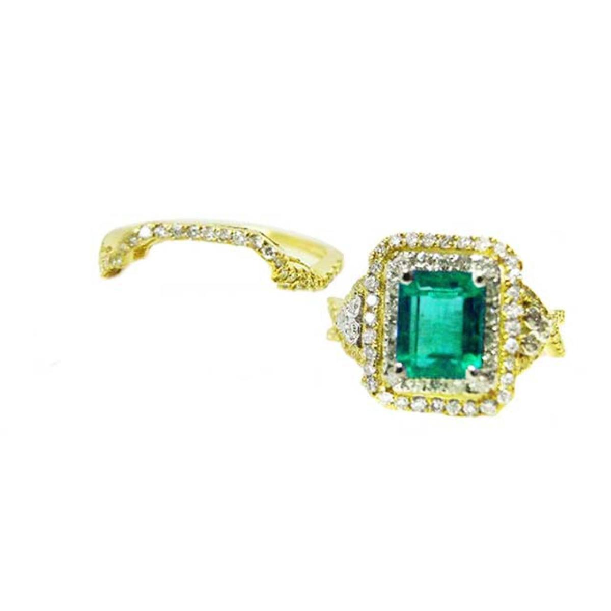 Topside of an emerald-cut emerald ring with double halo diamond and aside the matching band.