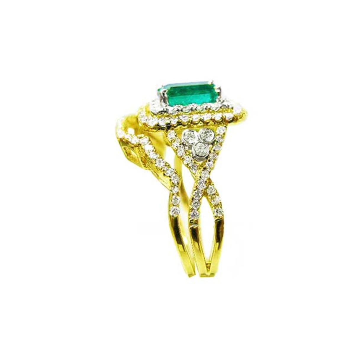 A side profile view of a natural emerald ring with the matching band and accent diamonds in yellow gold.