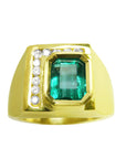 A 18k yellow gold colombian emerald ring for men with diamond accents on a topside view position.