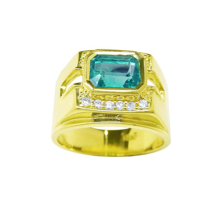 A bezel set natural emerald ring foe men topside and profile side visibles.