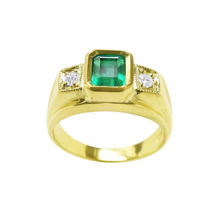 Men's gold ring with a rectangular emerald-cut emerald and two diamonds on a white background