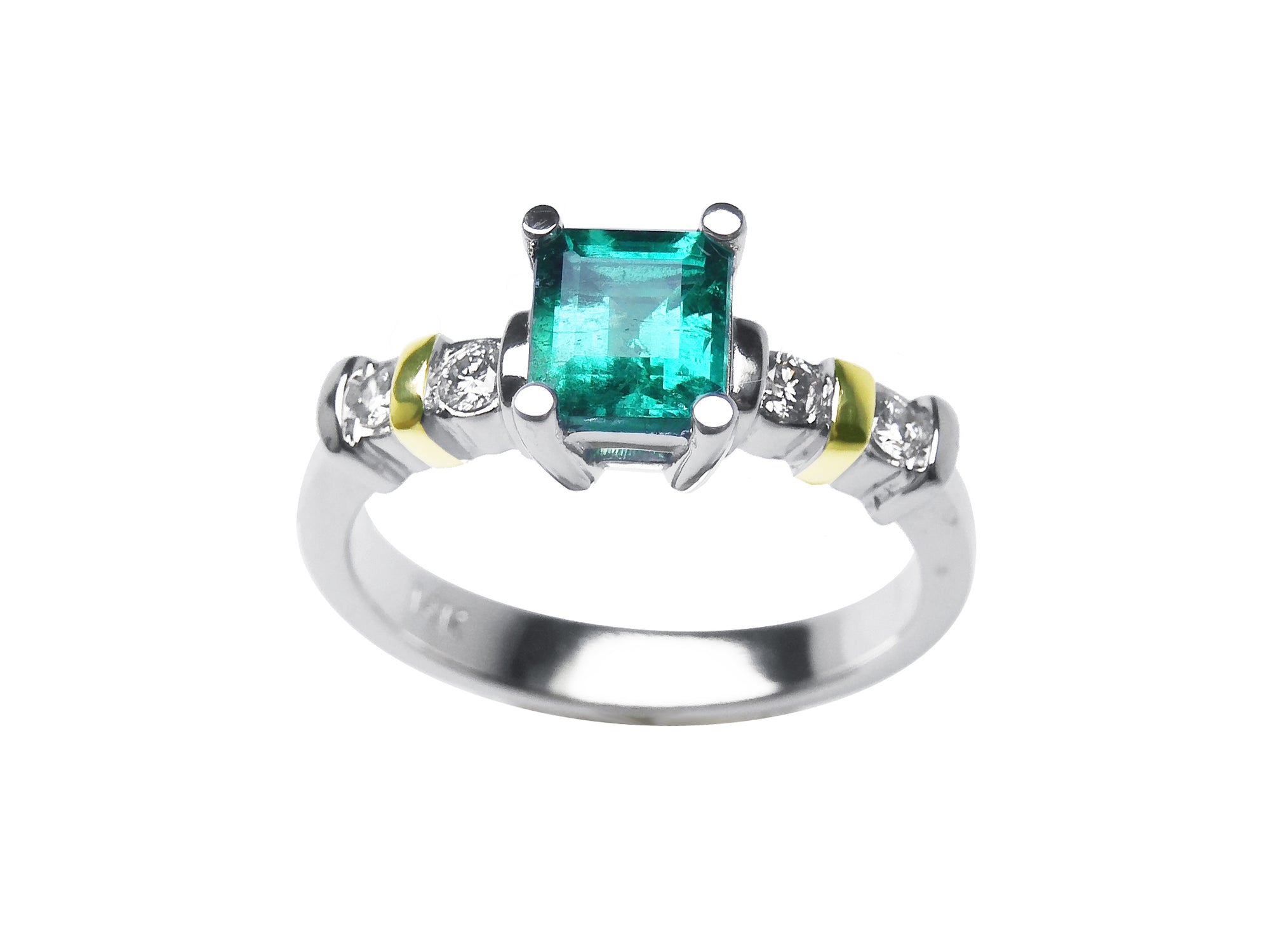 White gold emerald with accent diamonds ring on a white background.