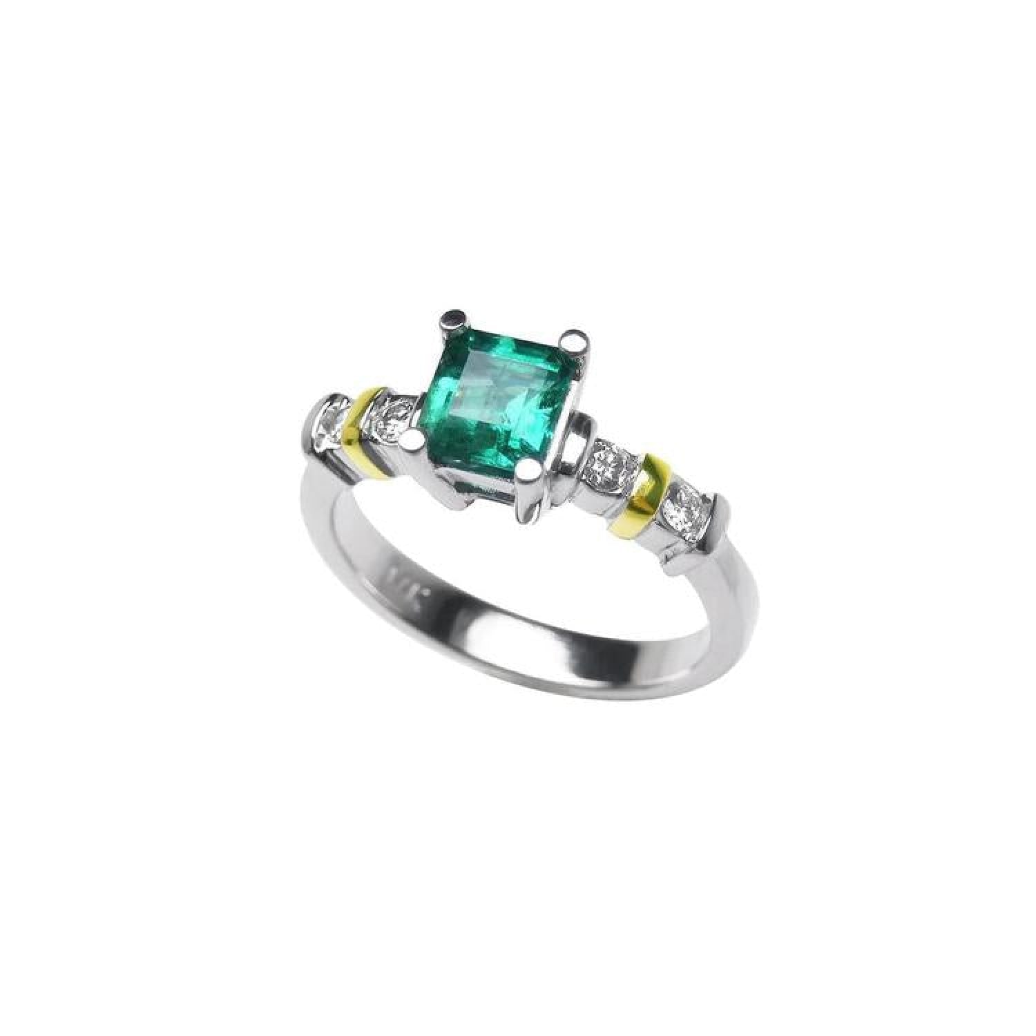 14K white gold ring with a square emerald cut Colombian emerald and side diamonds, accented with gold bands.