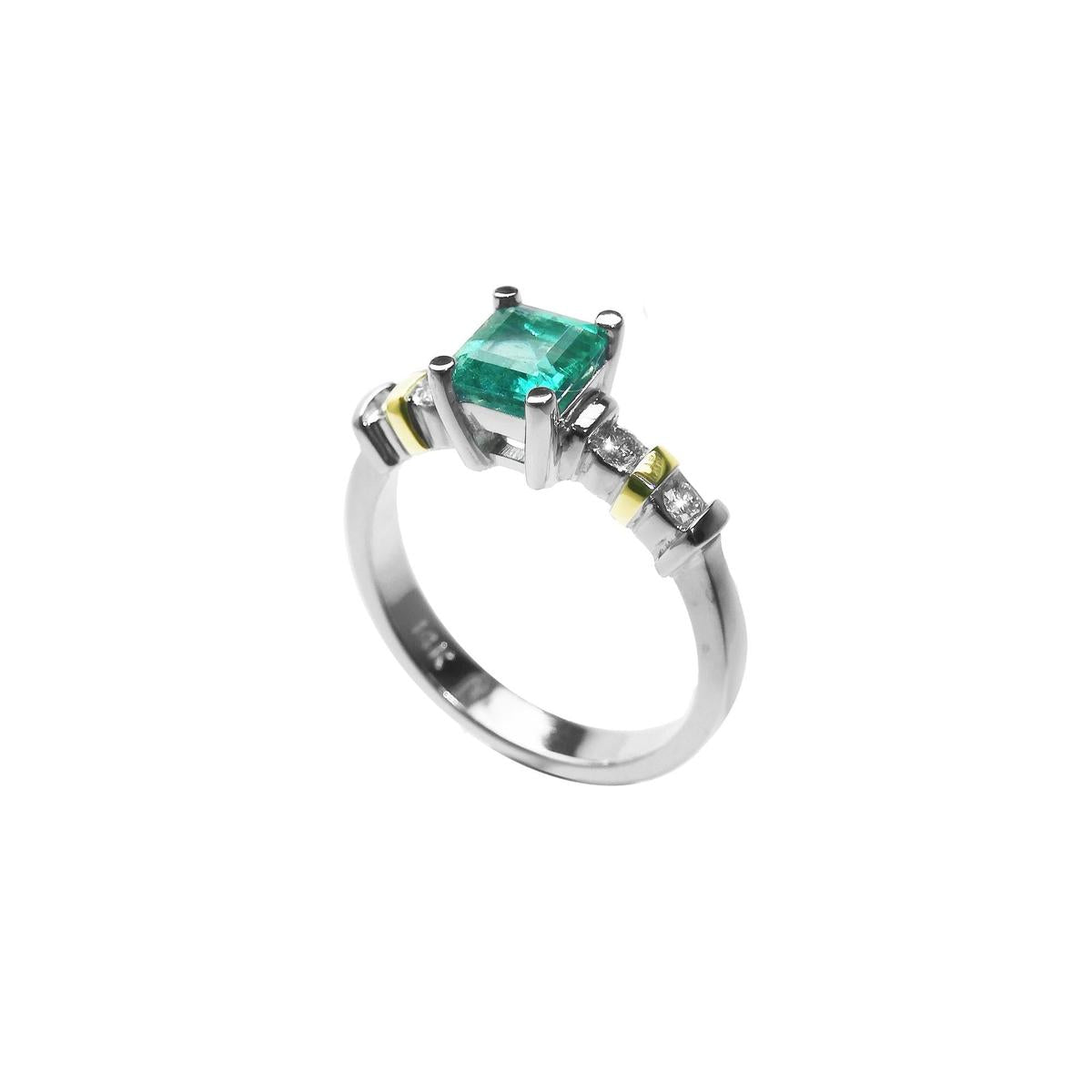 A square emerald with accent diamonds white gold ring.