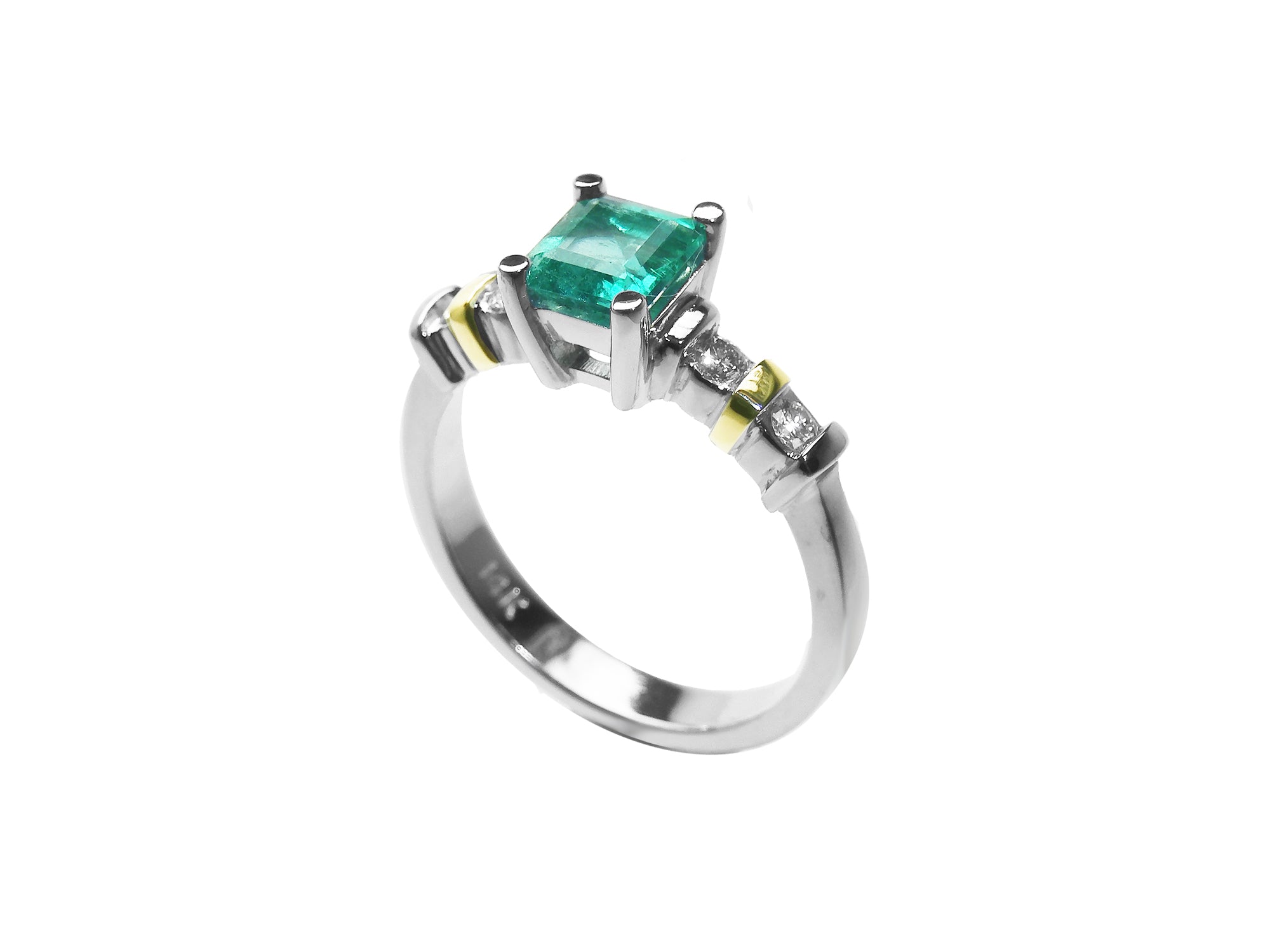 A square emerald with accent diamonds white gold ring.