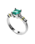 A square emerald with accent diamonds white gold ring.