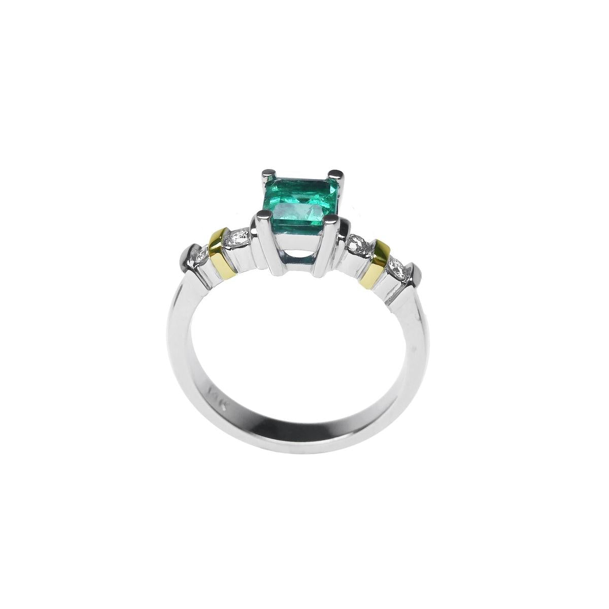 White gold emerald and accent diamonds ring lateral profile.