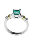 White gold emerald and accent diamonds ring lateral profile.