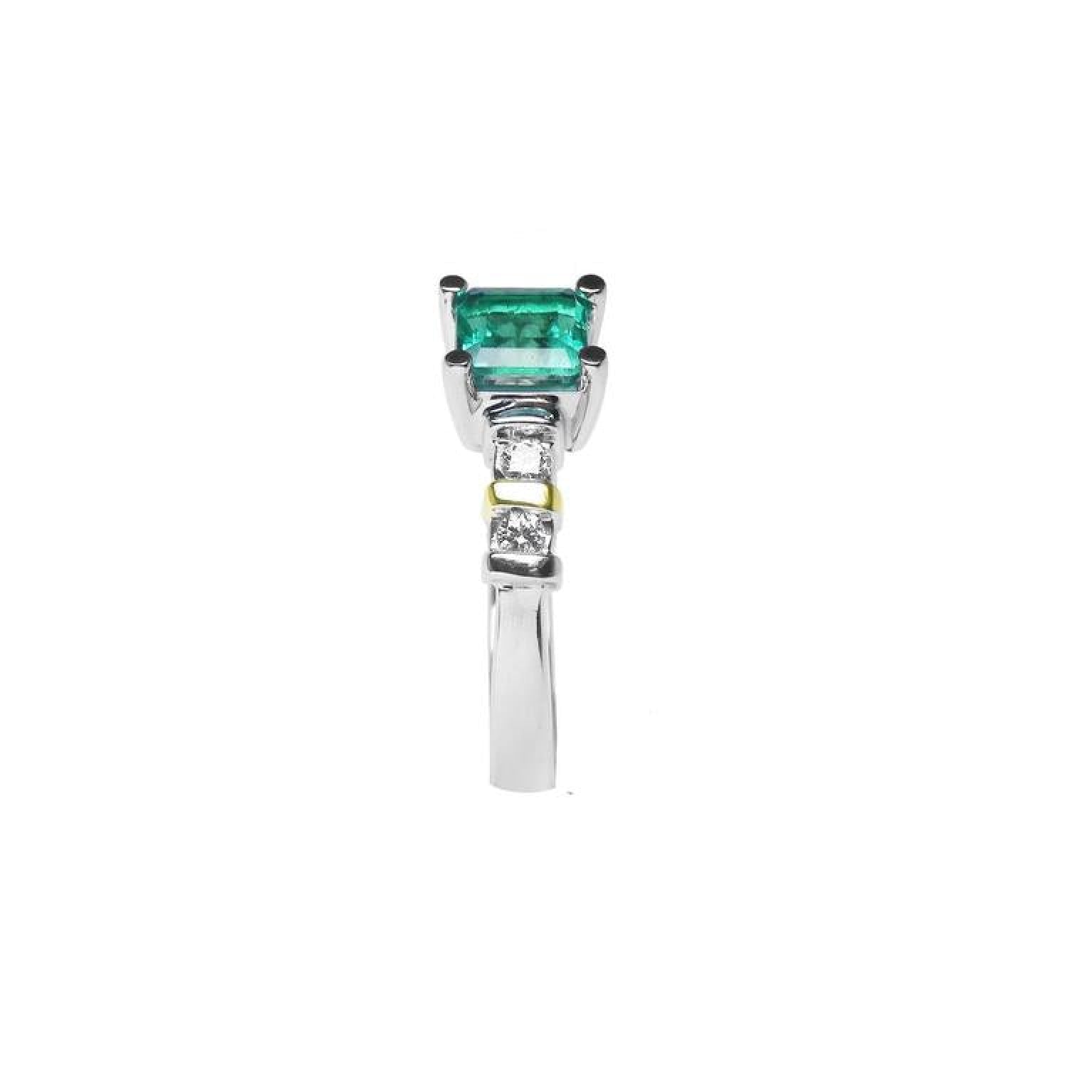 14K white gold ring with a square emerald cut Colombian emerald and side diamonds.
