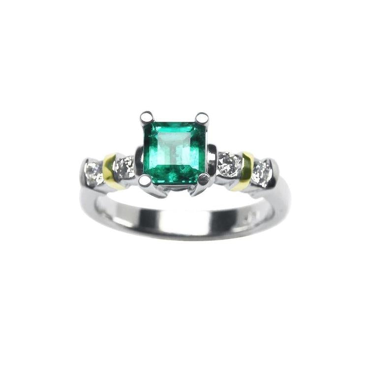 A square natural colombian emerald and accent diamonds ring made of 14k white gold.
