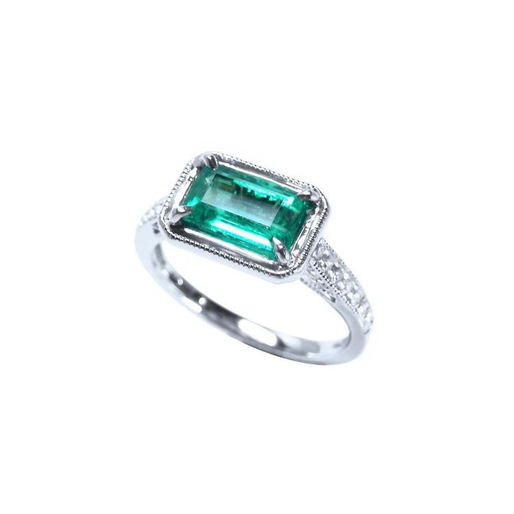 Emerald-cut emerald ring with natural diamonds in 14K white gold.