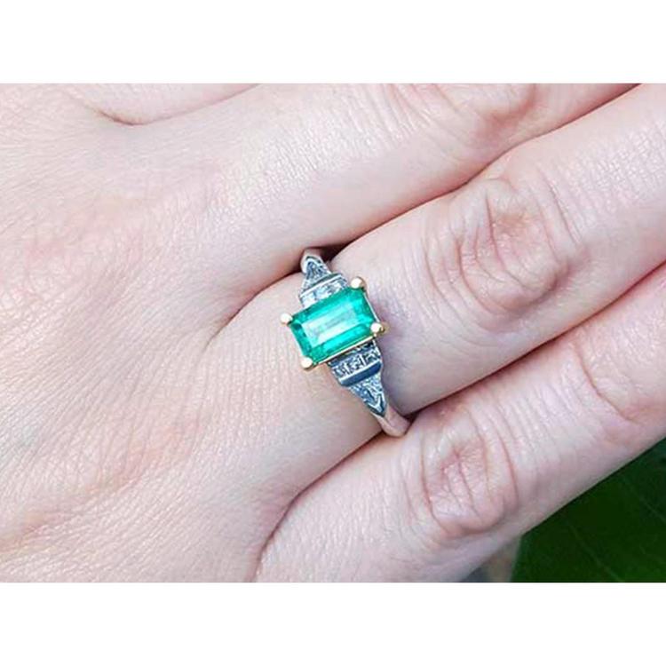 A platinum and 18k gold emerald ring for women with a natural colombian emerald and diamonds.