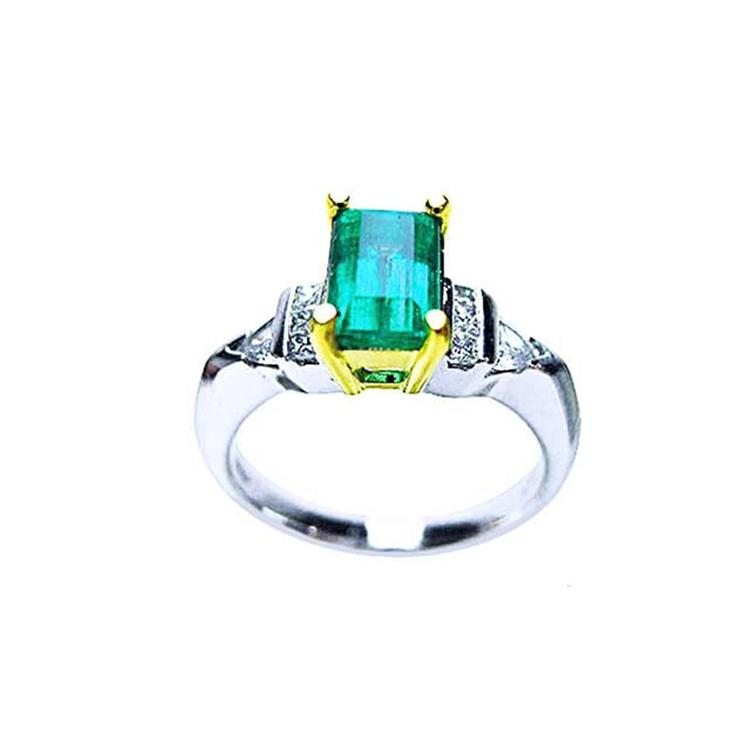 Platinum and 18K yellow gold ring with a 1.21 ct. emerald and natural diamond accents.