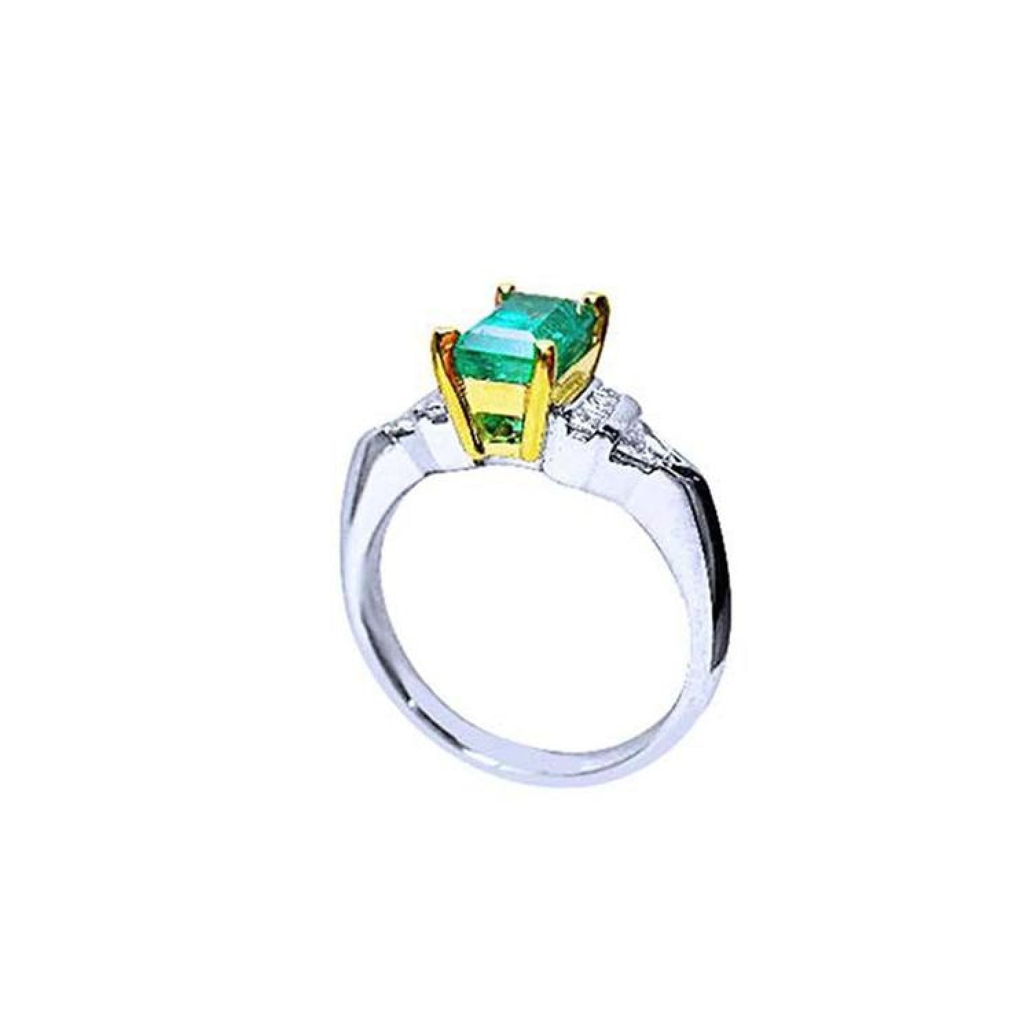 Platinum and 18K yellow gold emerald ring with round and trillion-cut diamond accents.