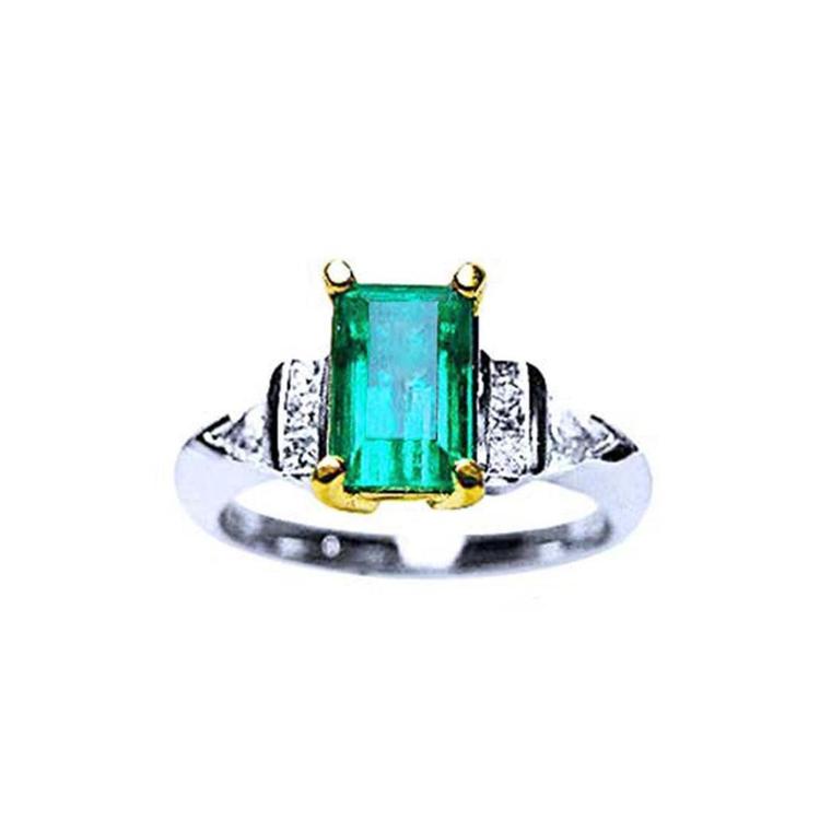 Platinum emerald ring and 18k yellow gold setting with accent side natural diamonds.