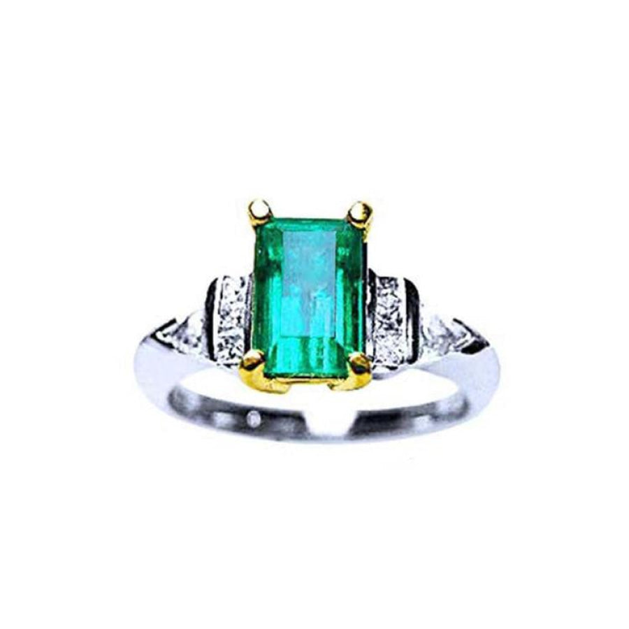 Platinum emerald ring and 18k yellow gold setting with accent side natural diamonds.