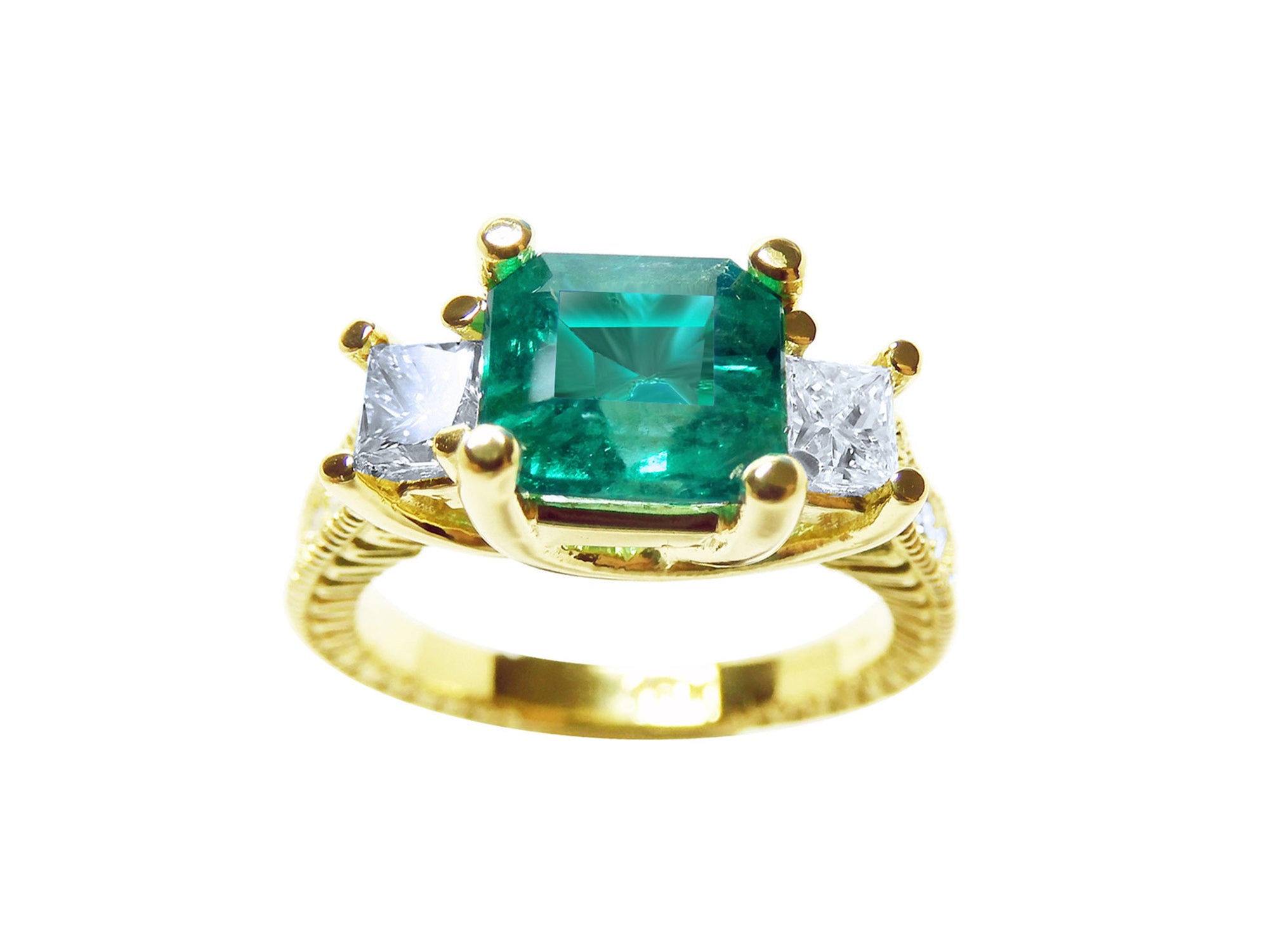 This emerald and princess cut side diamond ring is displaying the top and side profile view.