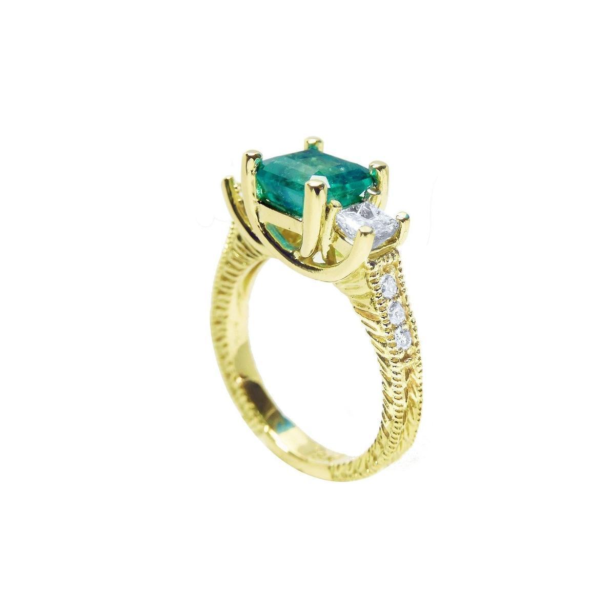 A half side profile of an emerald ring with side princess cut diamonds in 18k yellow gold.