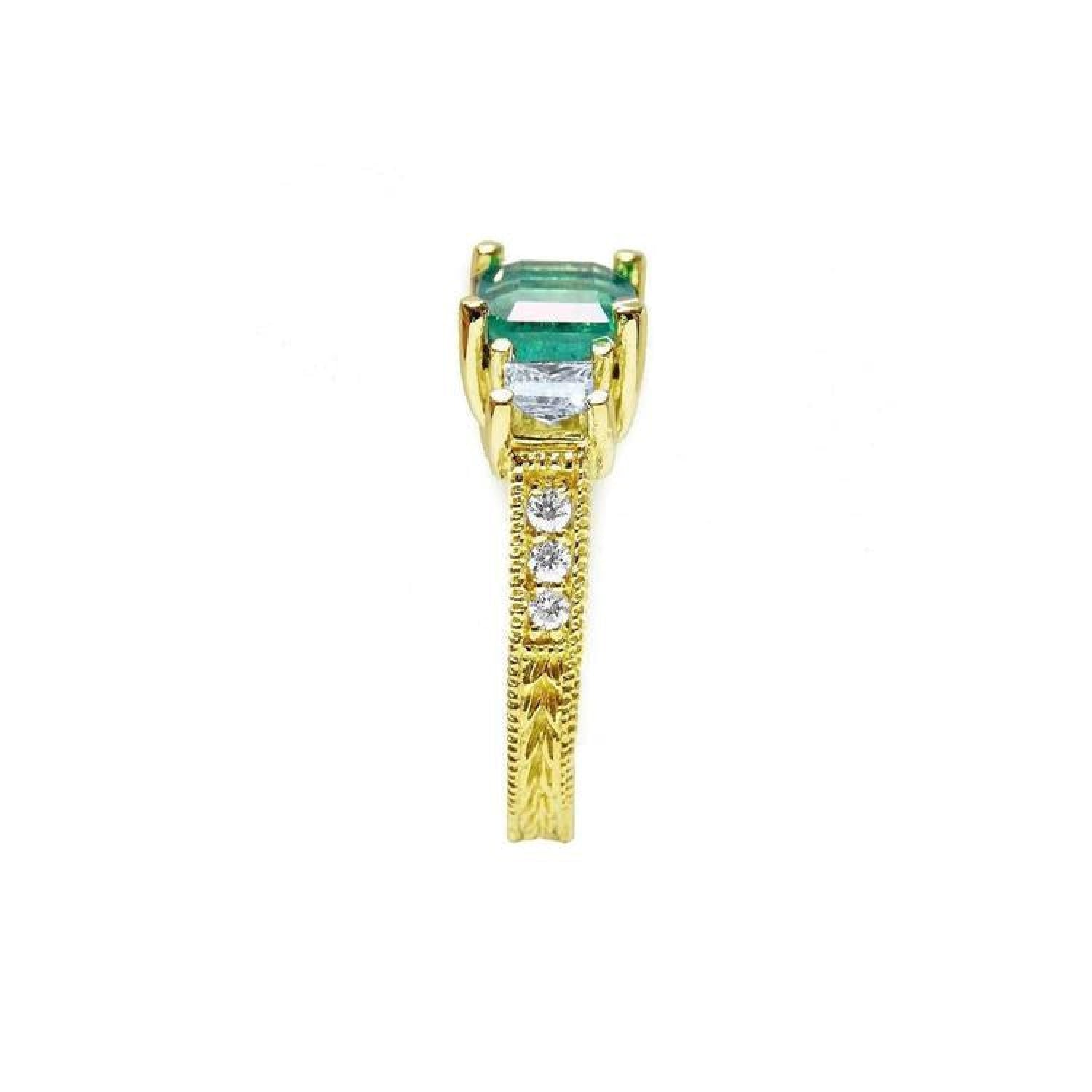 Emerald and princess cut side diamond ring in 18K yellow gold with antique decor.