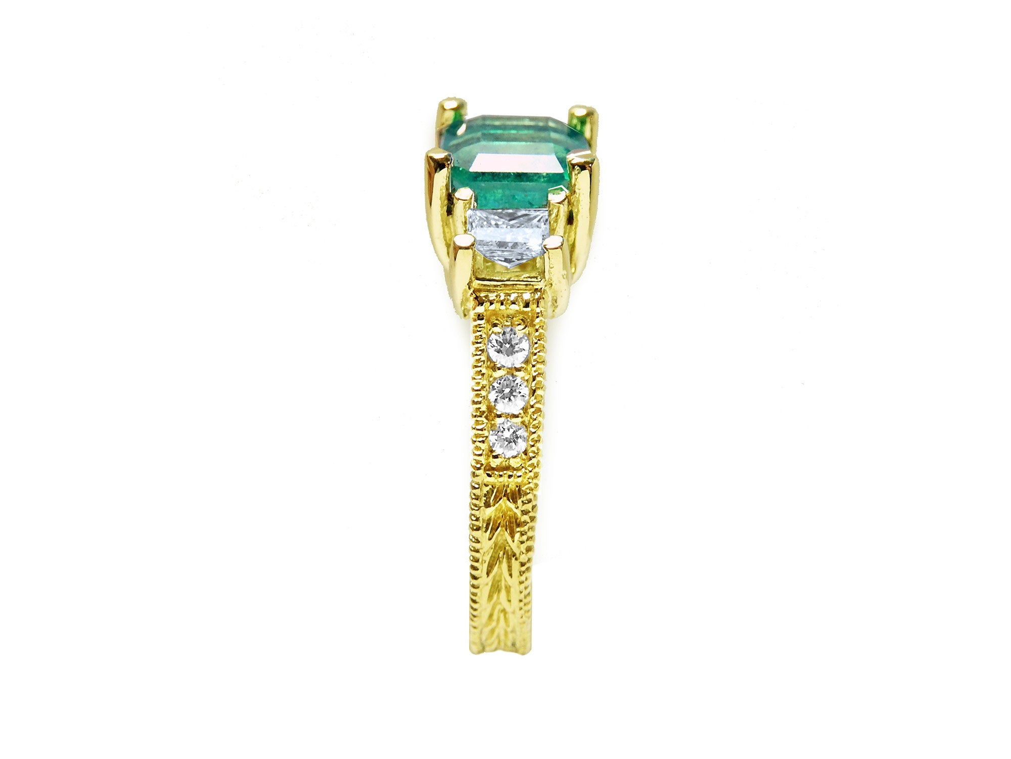 Emerald and princess cut diamond women&#39;s ring displaying it side profile from top to down.