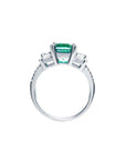 1.88 carat emerald ring with side emerald-cut diamonds and round accents in 18k white gold.