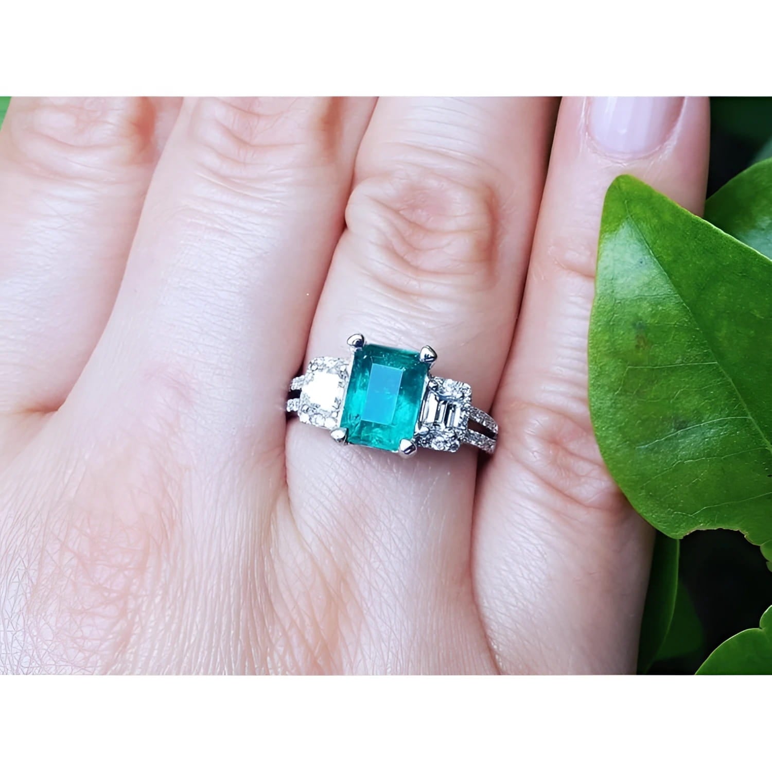 Natural colombian emerald and side emeral-cut genuine diamonds engagement ring.