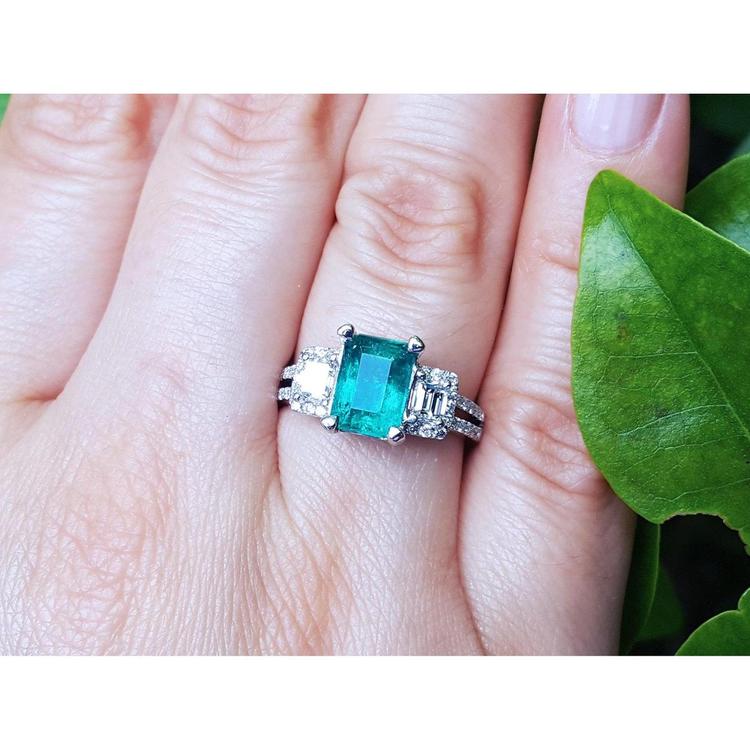 Natural colombian emerald and side emeral-cut genuine diamonds engagement ring.