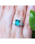 Natural colombian emerald and side emeral-cut genuine diamonds engagement ring.